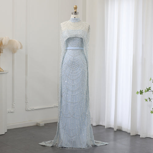 “Che’ Le Vout” Embellished Icy Blue Cape Gown – Velour de Luxe Award Couture
